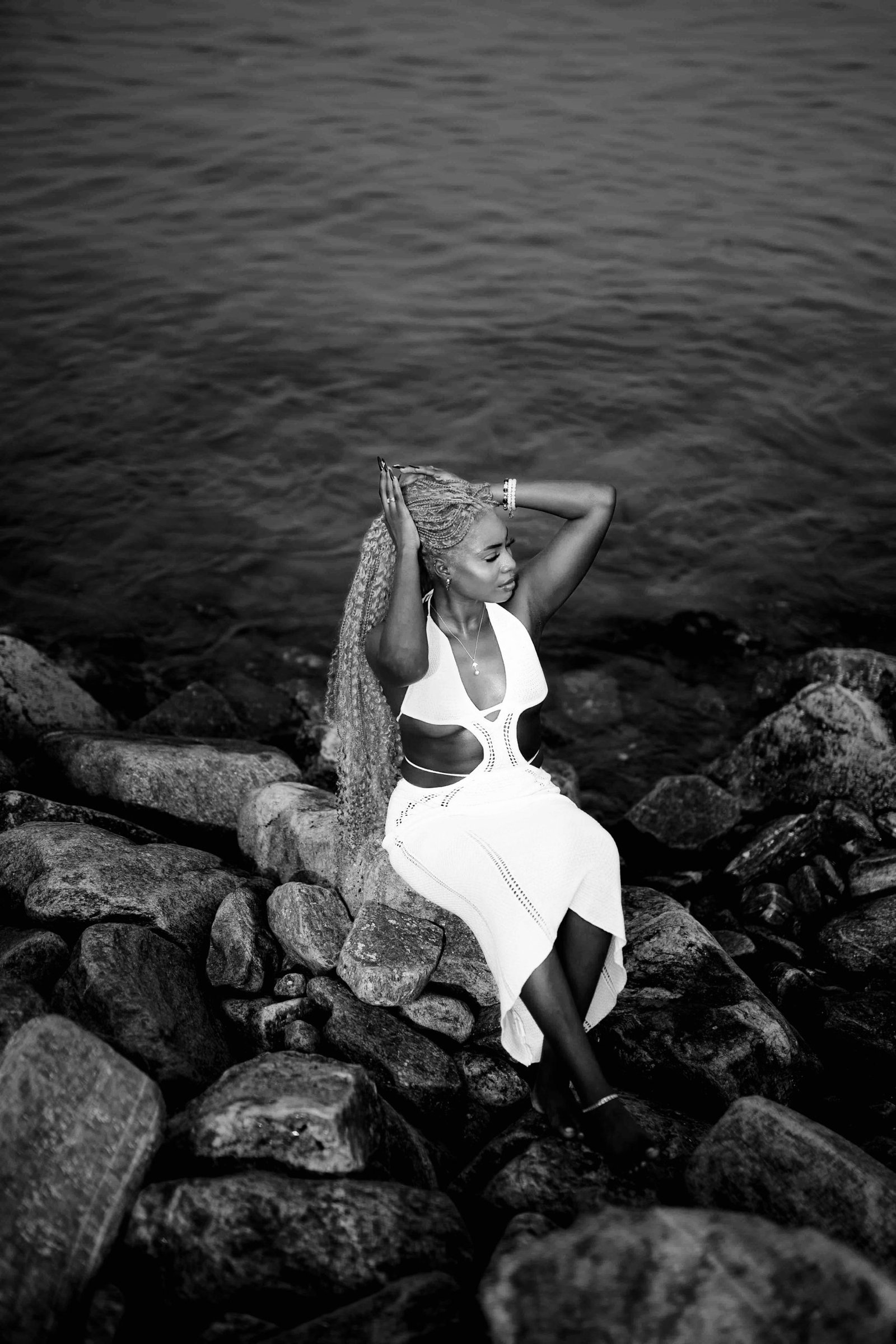 Solana sitting on a rock by the sea shore