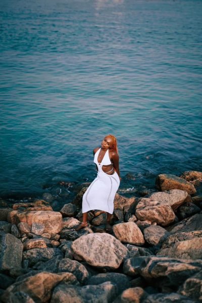 solana standing on rocks by the sea shore